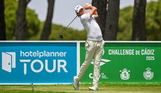 Cedric Gugler hits a tee shot with a driver