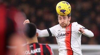 Luton Town's Tom Lockyer heads a ball in the Premier League clash against Bournemouth in December 2023, which was abandoned after he collapsed.