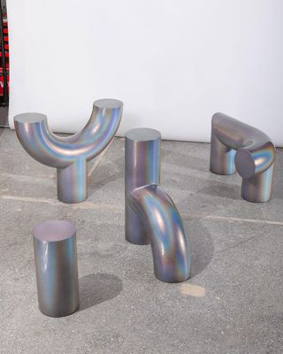 Four silver objects in abstract shapes