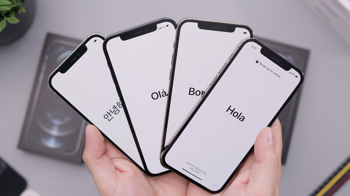 selection of iPhones held in a person&amp;#039;s hand, in boot-up mode