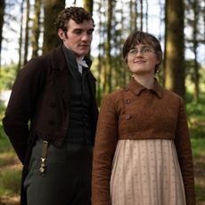 Mary Bennet (ELLA BRUCCOLERI) and Mr Hayward (D&Oacute;NAL FINN) stand in a forest, in 'The Other Bennet Sister.'