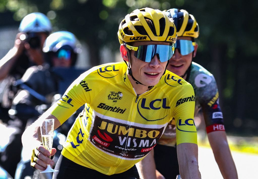 JumboVisma teams Danish rider Jonas Vingegaard wearing the overall leaders yellow jersey celebrates with champagne as he cycles during the 21st and final stage of the 109th edition of the Tour de France cycling race 1156 km between La Defense Arena in Nanterre outside Paris and the ChampsElysees in Paris France on July 24 2022 Photo by Thomas SAMSON POOL AFP Photo by THOMAS SAMSONPOOLAFP via Getty Images