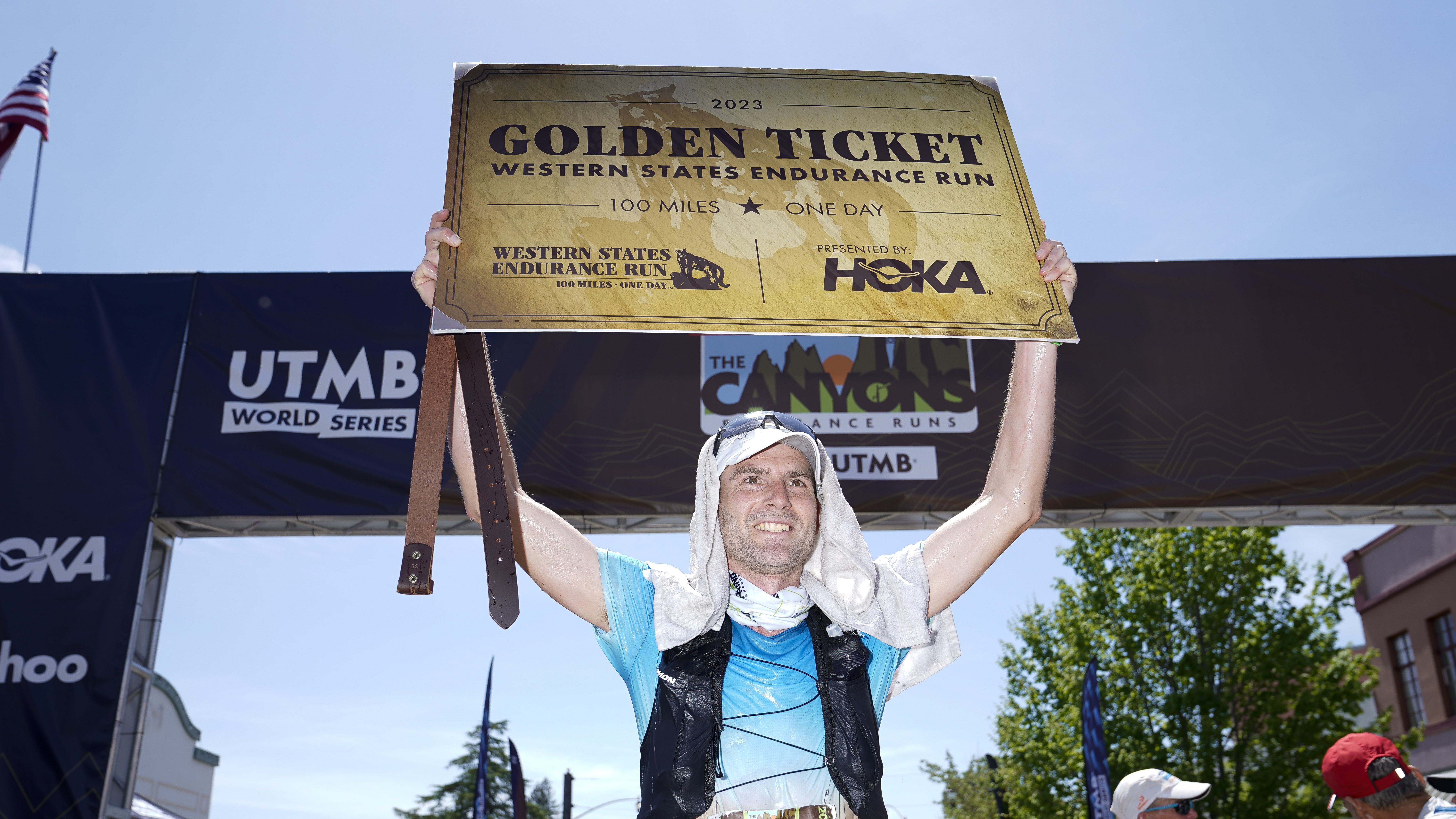 Cole Watson of the United States celebrates with a 2023 HOKA Golden Ticket for the Western States Endurance Run after winning the 100k race during the UTMB World Series Canyons Endurance Run