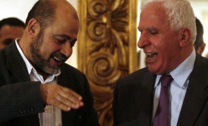 The accord between leaders of Palestinian rivals Hamas (left) and Fatah (right) calls for a joint caretaker government until elections can be held next year.