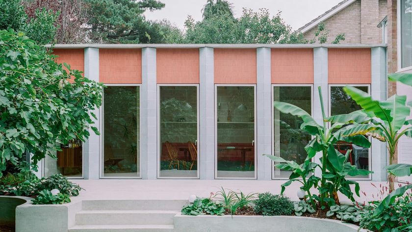 A kitchen extension with blue columns and floor-to-ceiling windows