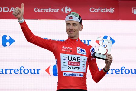 UAE Team Emirates - XRG team's Slovenian rider Tadej Pogacar celebrates on the podium wearing the overall leader's red jersey, after winning the first stage of the Vuelta a Espana 2026, a 9,4 km time-trial between Monaco and Monaco on August 22, 2026. (Photo by Miguel MEDINA / AFP)