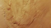 a reddish-orange rippled landscape, seen from over head