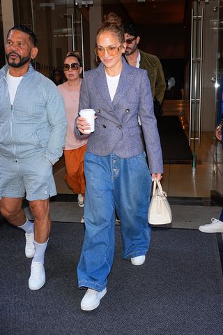 Jennifer Lopez wears blue jacket, baggy jeans and white sneakers in NYC