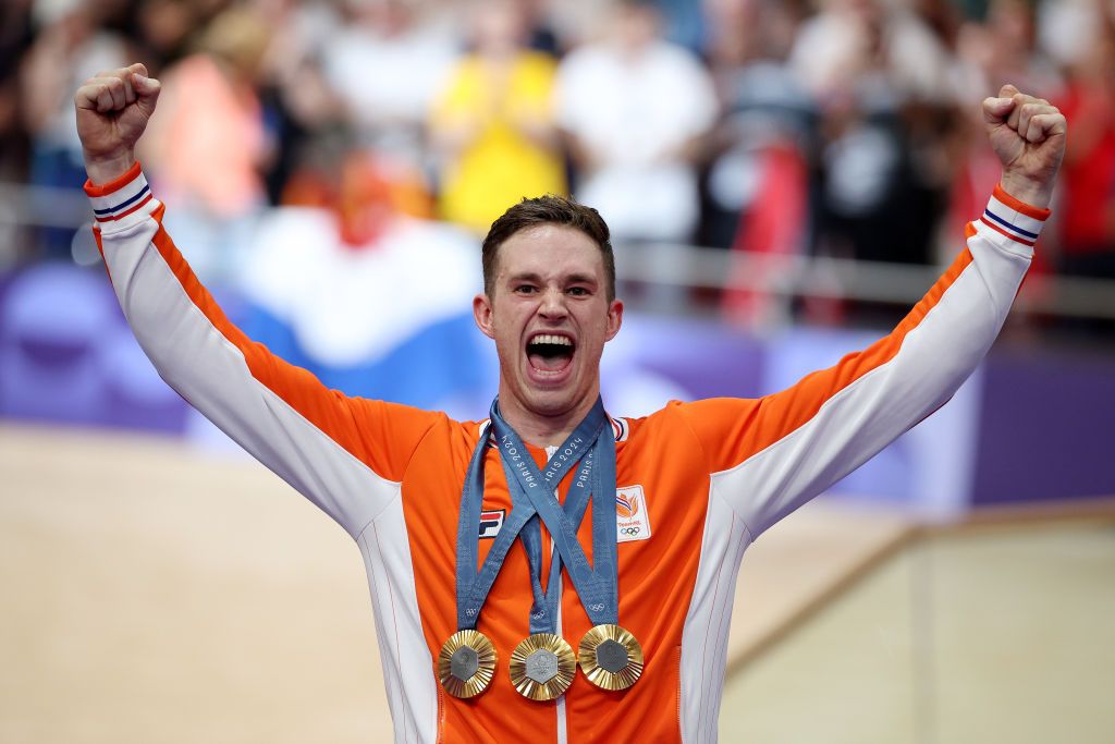 PARIS FRANCE AUGUST 11 Gold medalist Harrie Lavreysen of Team Netherlands celebrates on the podium with his Keirin Individual Sprint and Team Sprint gold medals after the Mens Keirin Final on day sixteen of the Olympic Games Paris 2024 at SaintQuentinenYvelines Velodrome on August 11 2024 in Paris France Photo by Jared C TiltonGetty Images