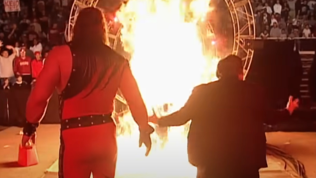 Kane and Paul Bearer setting Undertaker's casket on fire at the 1998 Royal Rumble