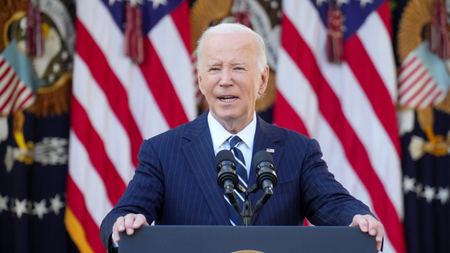 Joe Biden stands in front of American flags to deliver remarks on 2024 election results