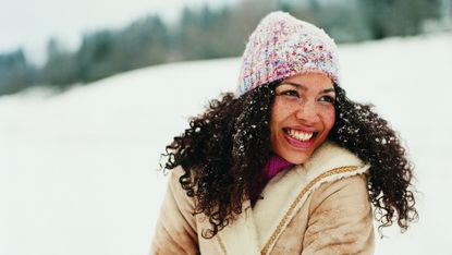 Portrait of a Young Woman Wearing a Hat in the Snow