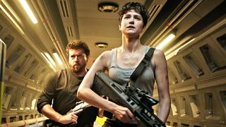 Katherine Waterson and Danny McBride storm a corridor forcefully in Alien: Covenant.