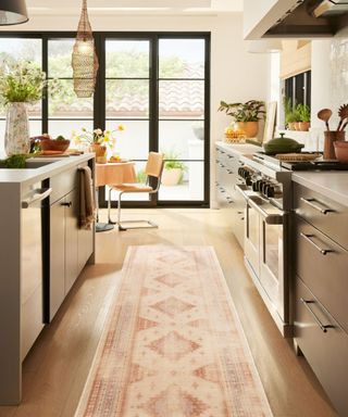 A light ruggable runner rug in a galley kitchen