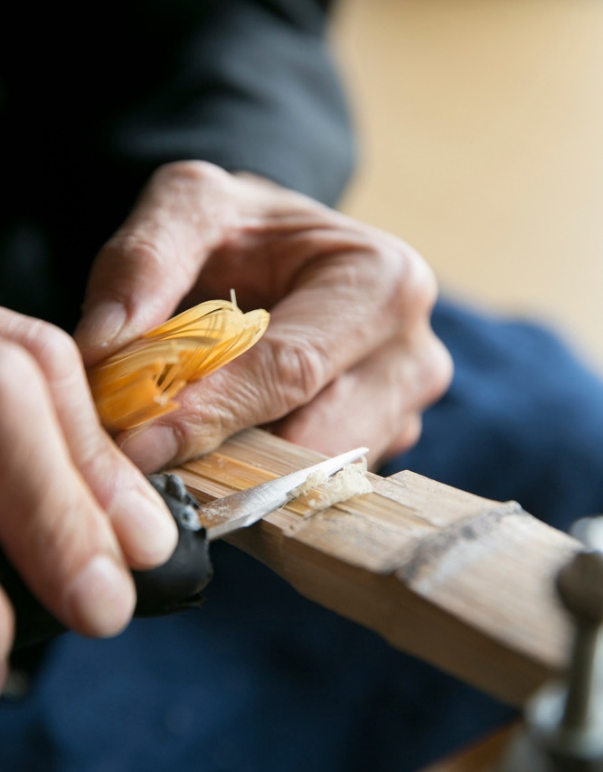 A close-up of a bamboo whisk being crafted
