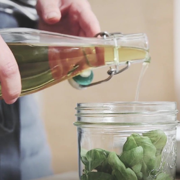 glass jar with basil leaves in it