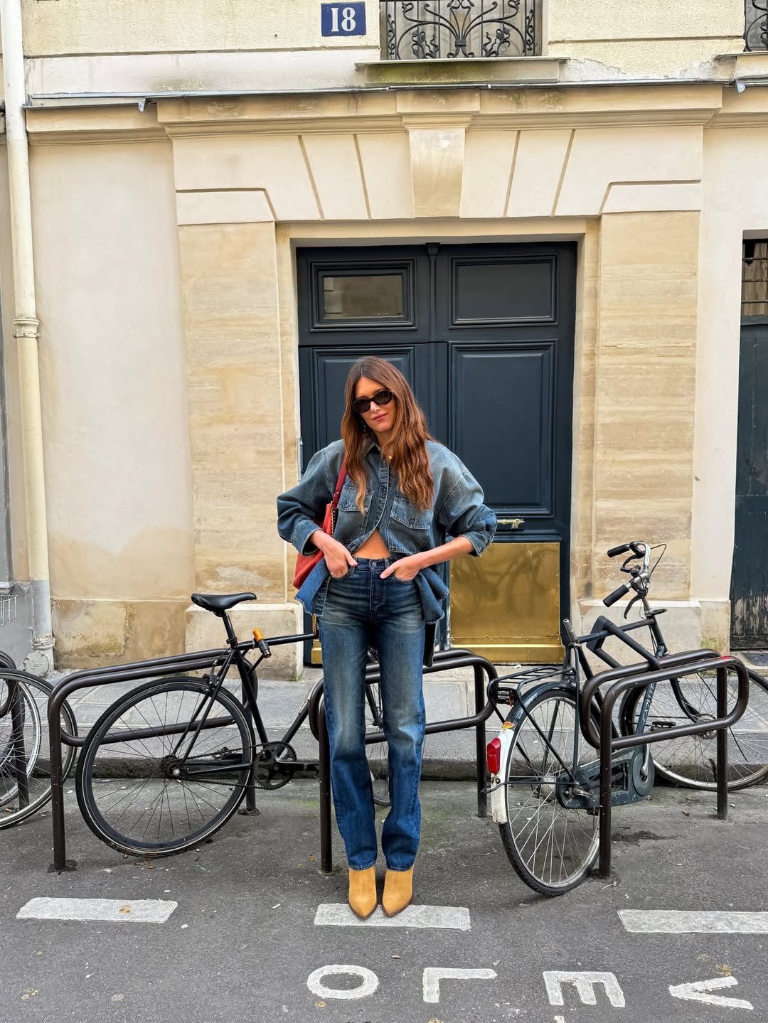 Sara Loura wearing high-rise bootcut jeans.