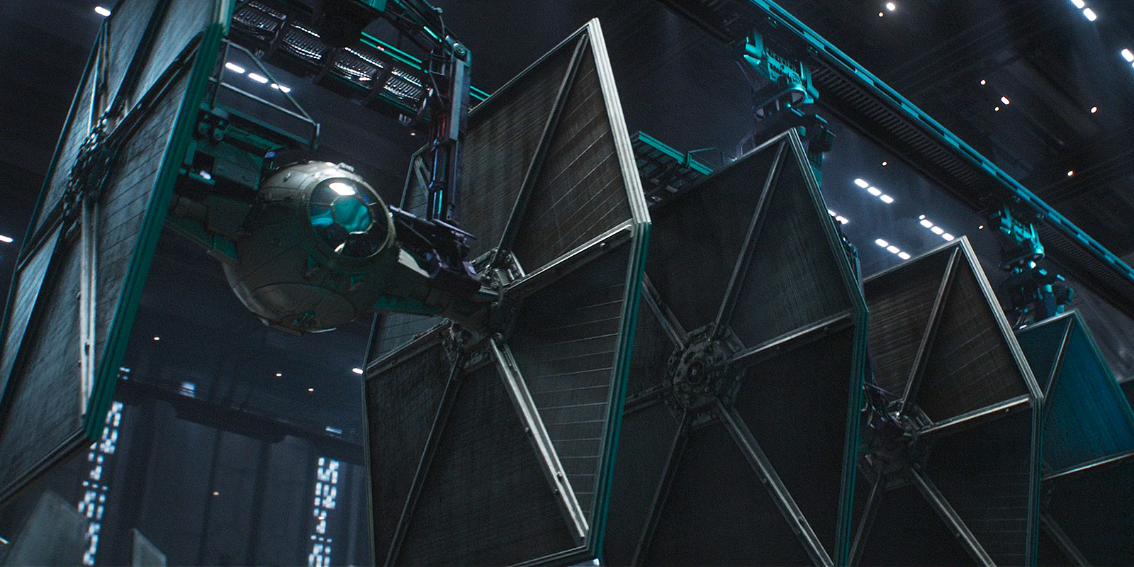 A still from Andor episode 6 showing TIE fighters in a rack.