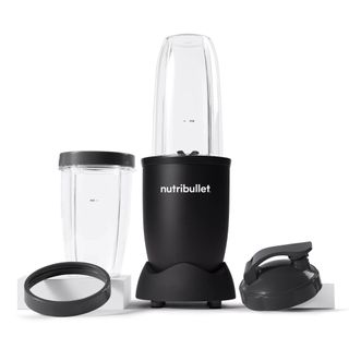 A Nutribullet Pro 900 blender with its cups on a white background