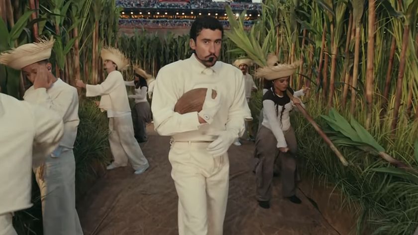 Bad Bunny holding football walking through fields during Super Bowl LX Halftime Show