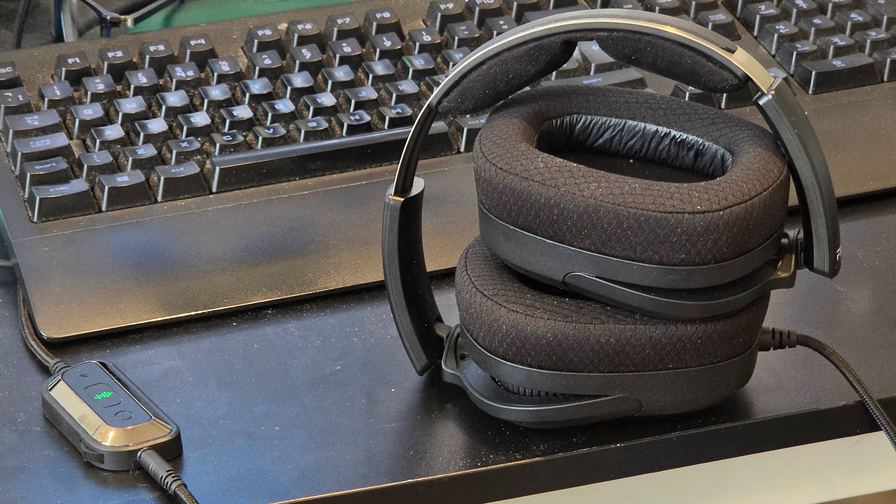 The FiiO FG3 folded on a desk, next to the audio controller and a keyboard.