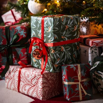 christmas presents wrapped under a christmas tree 