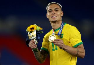 Antony celebrates with his gold medal after Brazil's win over Spain in the final of the men's football tournament at the 2020 Olympics in Tokyo.