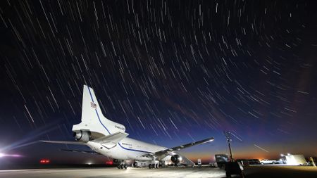 the flight path of a plane is shown around an airland, landing strip, and a small white rocket on the bottom right.