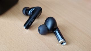 Denon Noise Cancelling Earbuds lying on a table