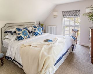 Blue and white bedroom in coastal cottage in Northumberland