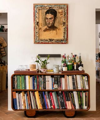 Book shelf with home bar on top with print on wall