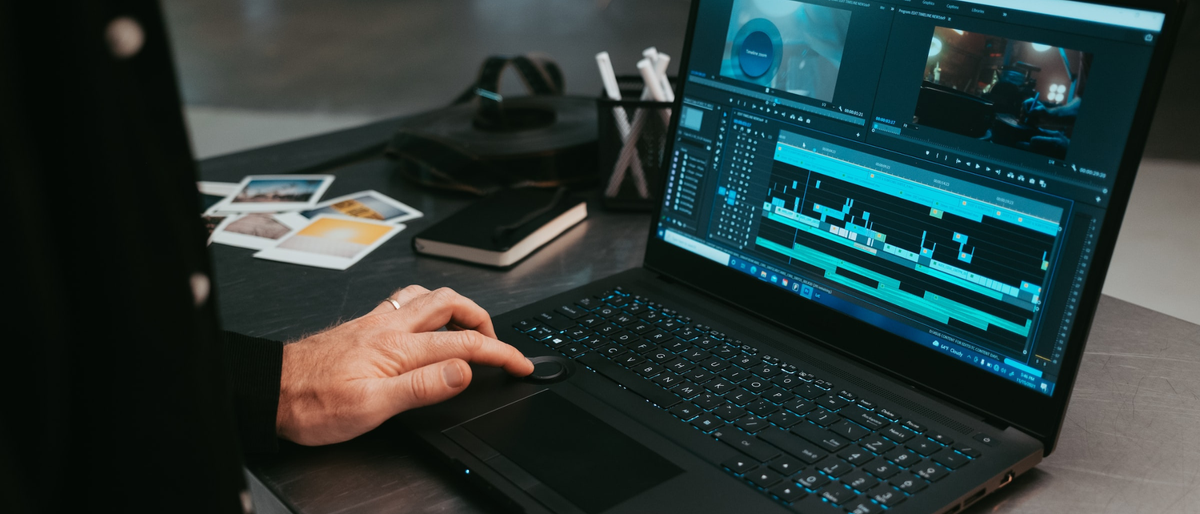 Man using video editor on laptop