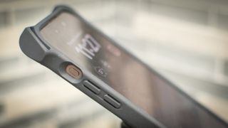 iPhone 15 Pro Max in a case, showing the action button from the side