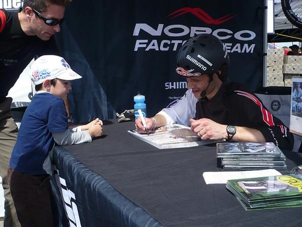 Trials rider Ryan Leech signs autographs.
