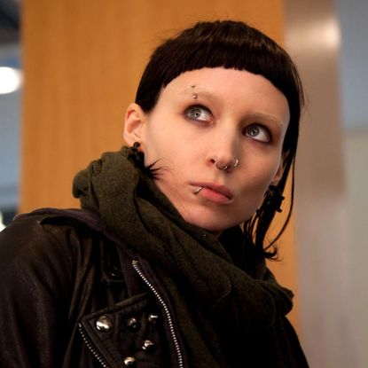 rooney mara with black hair and piercings in a still from the girl with the dragon tattoo