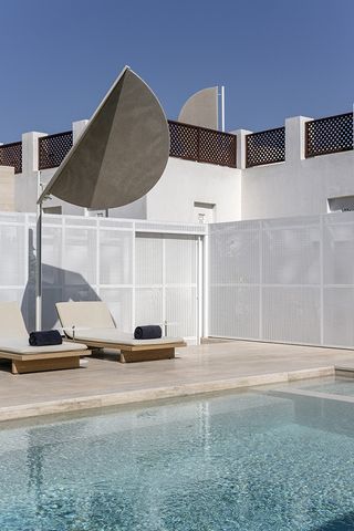 The Serai Wing lounger and shade