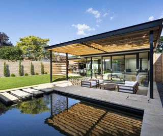 outdoor pool feature with stepping stones and covered seating area