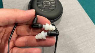 Shure Aonic 3 in-ear headphones pictured in hand