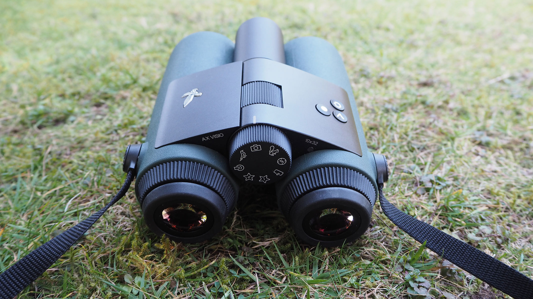 Swarovski AX Visio on some grass with dials and buttons visible.