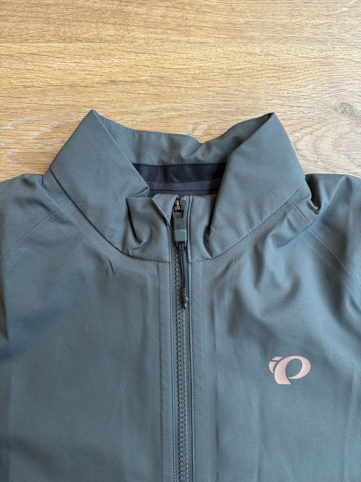 Flat lay jacket, collar and zip with small pearl izumi logo on the right breast