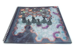 The five miniatures on one of the mission maps in the board game Mass Effect: Priority Hagalaz.