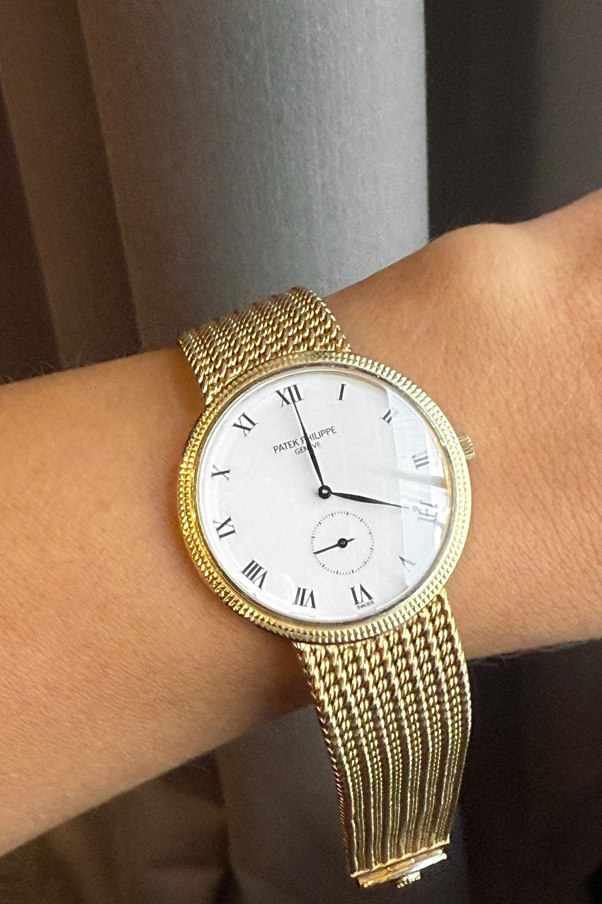 a woman wearing a gold watch