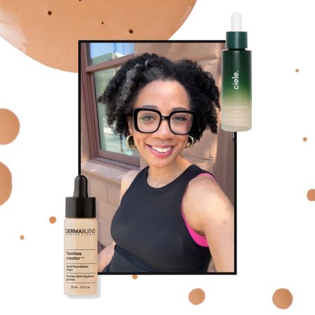 a background of foundation drops with an image of a girl framed with black hair, black glasses, black shirt, and a pink tank top next to two foundation drops