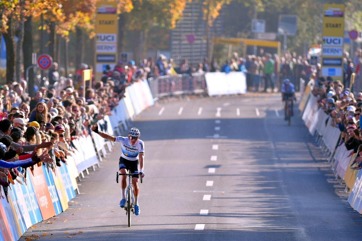 Mathieu van der Poel celebrates with Wout van Aert in the background