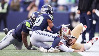 San Franscico 49ers quarterback Brock Purdy sliding out of bounds against the Seattle Seahawks