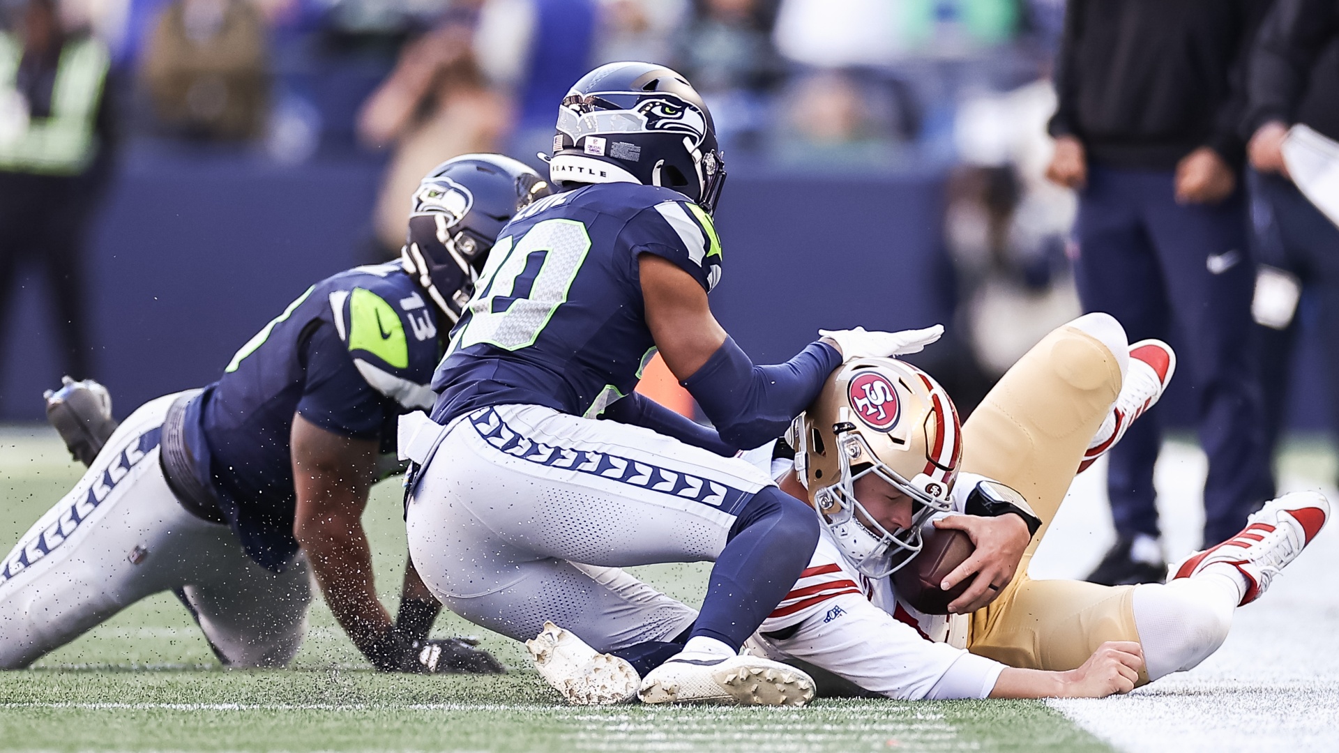 San Franscico 49ers quarterback Brock Purdy sliding out of bounds against the Seattle Seahawks