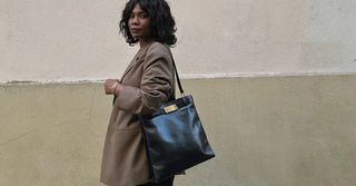 Woman wearing tote bag.