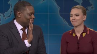 Michael Che attempts to give Scarlett Johansson a high five during Weekend Update.