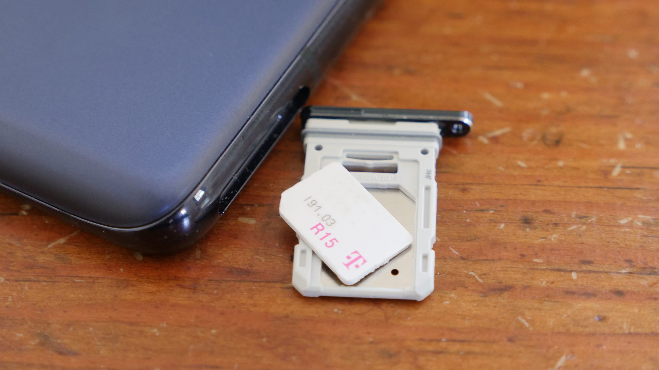 A T-Mobile SIM card on the SIM tray