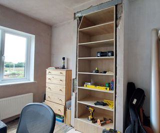 bookcase installed in chimney breast